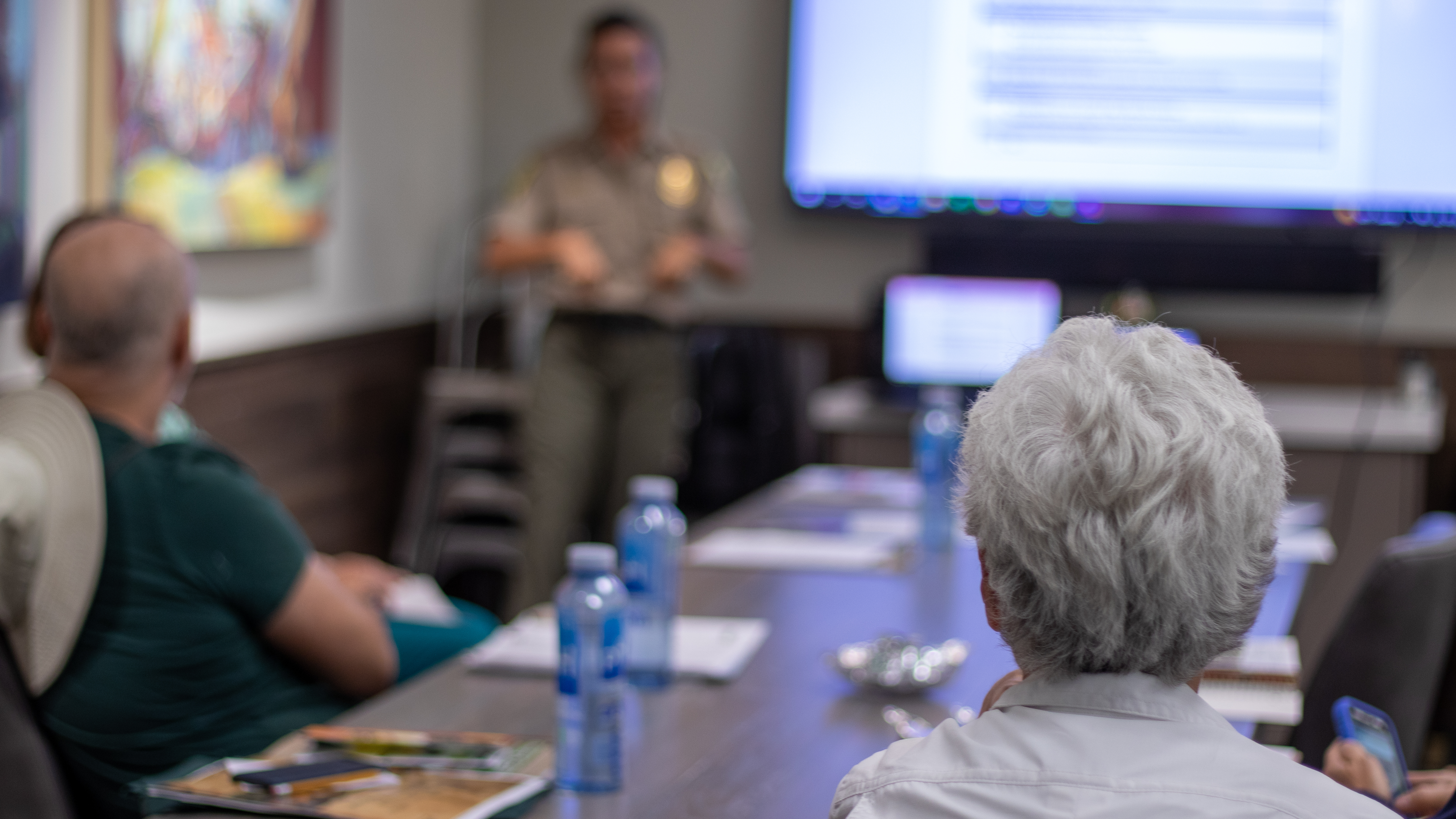 A resident of Galena Country Estates attends a presentation by Kelli Nevills, who is standing in the background.