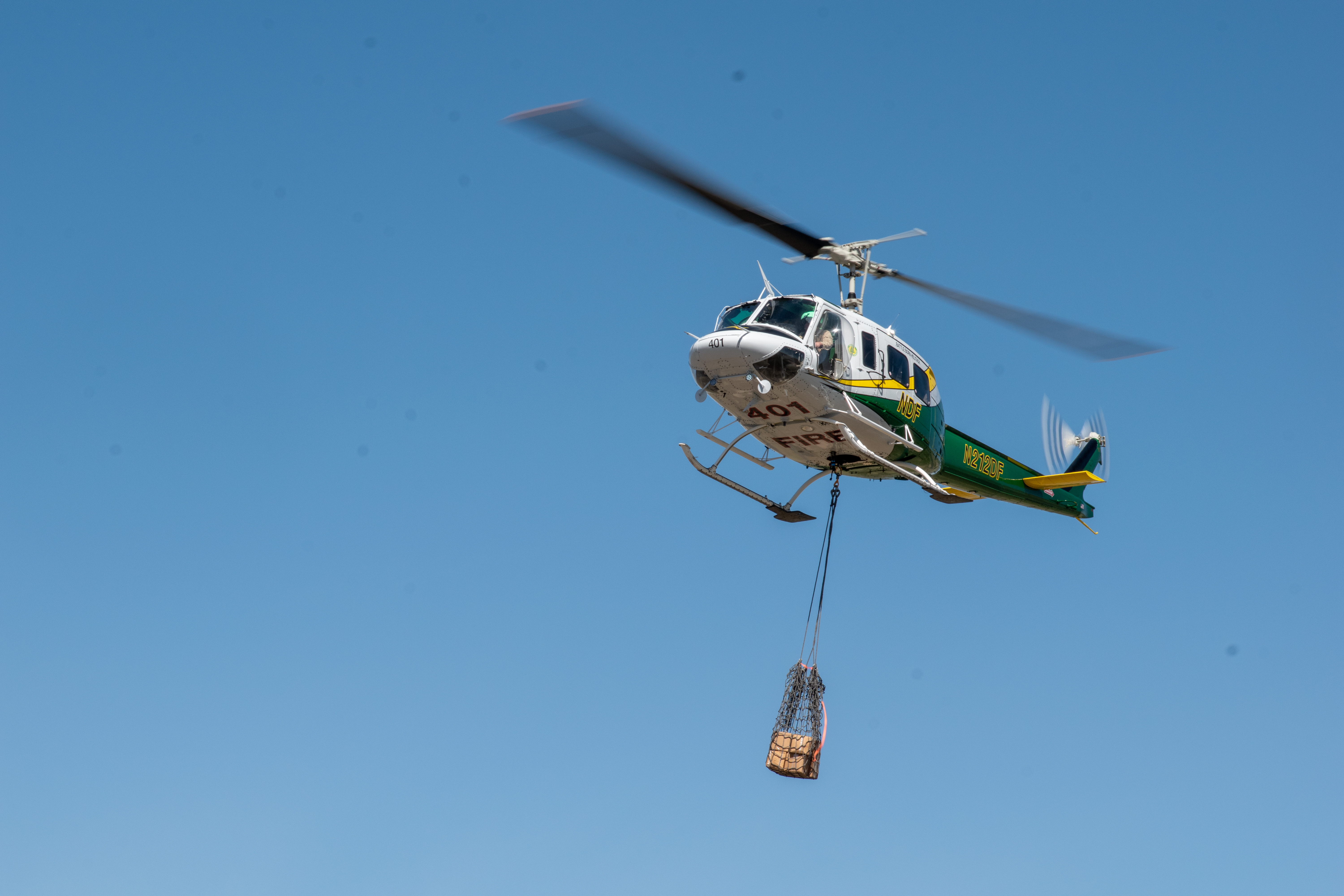 Helicopter H-401 hauling cargo with a short line. 